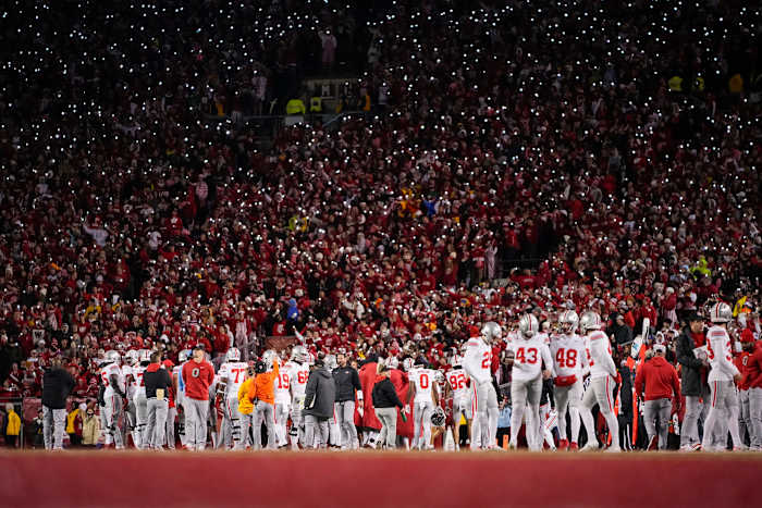 Oct 28, 2023; Madison, Wisconsin, USA; Wisconsin Badgers fans hold their cell phones with flashlights on as the Ohio State Buckeyes huddle during the second half of the NCAA football game at Camp Randall Stadium. Ohio State won 24-10.